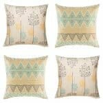 Four cushion with aztec print and plant pattern in pastel hues.