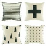 4 cushion with cross,pine tree and stripe prints in black colour..