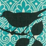 closer look at cushion with Teal Ikat and Black Bird pattern.