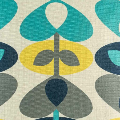 closer look at cushion cover with Teal Yellow and Grey Stem pattern.