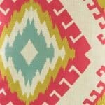 closer look at cushion with Red Yellow and Teal Ikat pattern.