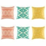 Three Pairs of Multi Patterned cushion with tribal, ikat and geometric patterns in orange,teal and yellow colours.
