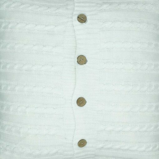 closer look at the front side of a white buttoned cable knit fabric cushion.