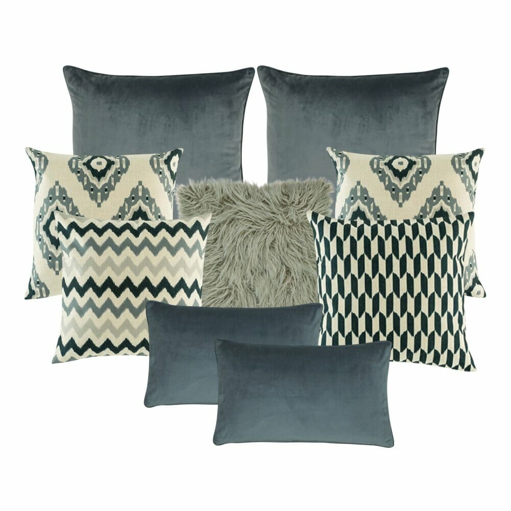 A pair of plain grey cushion cover, a pair of cream and grey cushion cover with diagonal patterns, a grey fur cushion, a cushion cover with zigzag pattern, a chevron cushion cover and two plain rectangular cushion in grey