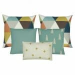 2 cushion cover with triangular design, 2 teal cushion cover in plain and with pine design and 1 rectangular cushion cover with yellow cross design