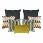 A rectangular cushion in mustard, a pair of black and white patterned cushion, a grey, pink, and yellow patterned cushion , a two plain grey cushion