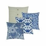 Three piece patterned square cushion in blue and white colours and one cable knit with buttons design cushion.