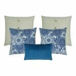 Two cushion covers in cable knit design with buttons, two patterned cushion covers in blue and white colours and one blue cushion cover in rectangular shape.