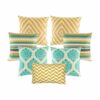 Four multi patterned cushion in gold and teal colours with diamond, zigzag and crown designs.