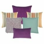 One plain violet cushion, two patterned cushion in orange and teal colours, one fur cushion in lilac,one plain cushion in teal and one rectangular cushion in violet colour.