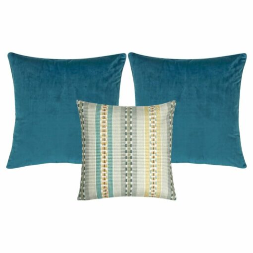 A patterned cushion and two plain blue cushion