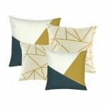 two white,gold and grey patterned cushion and two cushion in linear gold and white pattern.