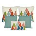 A pair of diagonal patterned cushion cover in light pink, blue and green colours, a pair of light blue cushion cover, and one rectangular cushion with diamond pattern