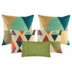 A pair of cushion with diagonal patterns, two pieces of cushion with triangle patterns, and one green rectangular cushion