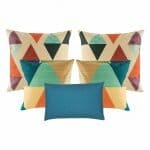 four pieces of multicolored cushion cover and one blue rectangular cushion cover