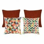 A pair of plain red cushion covers, and two pieces of rainbow coloured cushion covers