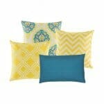 Two patterned cushion in white and yellow, one blue and yellow patterned cushion. and one rectangular blue cushion.