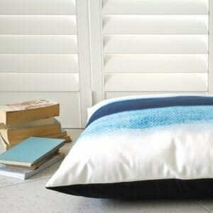 Floor cushion in blue and white, perfect for a reading nook.