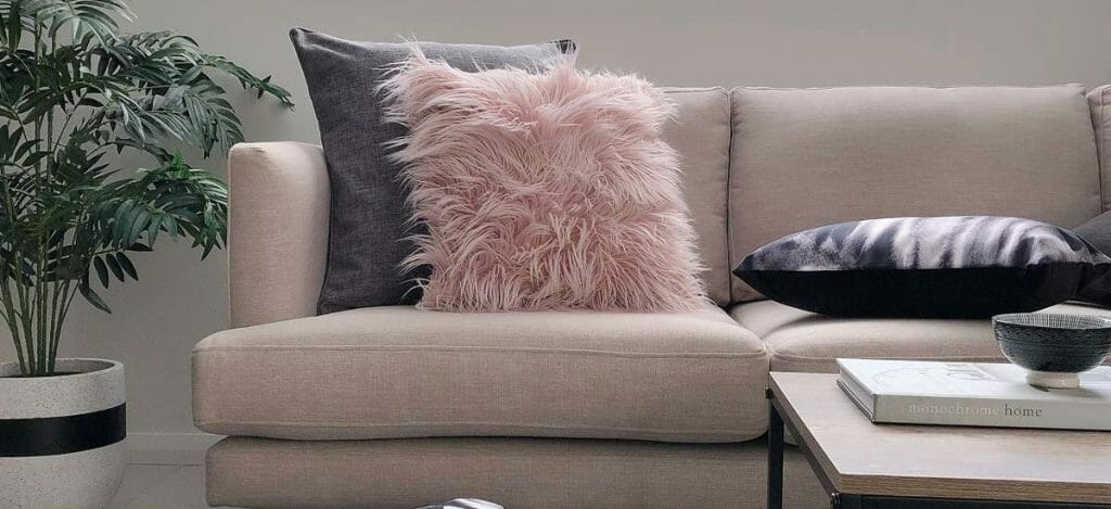 Pink faux fur cushion with a grey cushion to add a little character to the room.