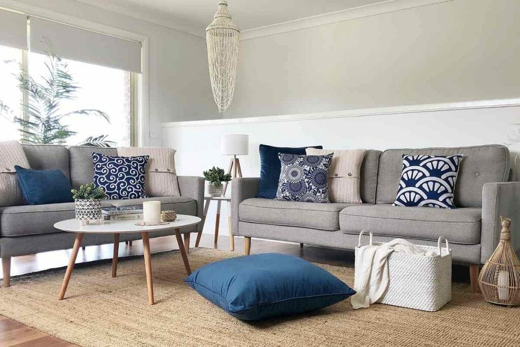 Cozy sofa decorated with decorative navy and white cushions