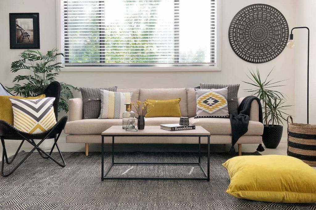 Neutral sofa accentuated with patterned and texture cushions in grey and mustard for a pop of colour.