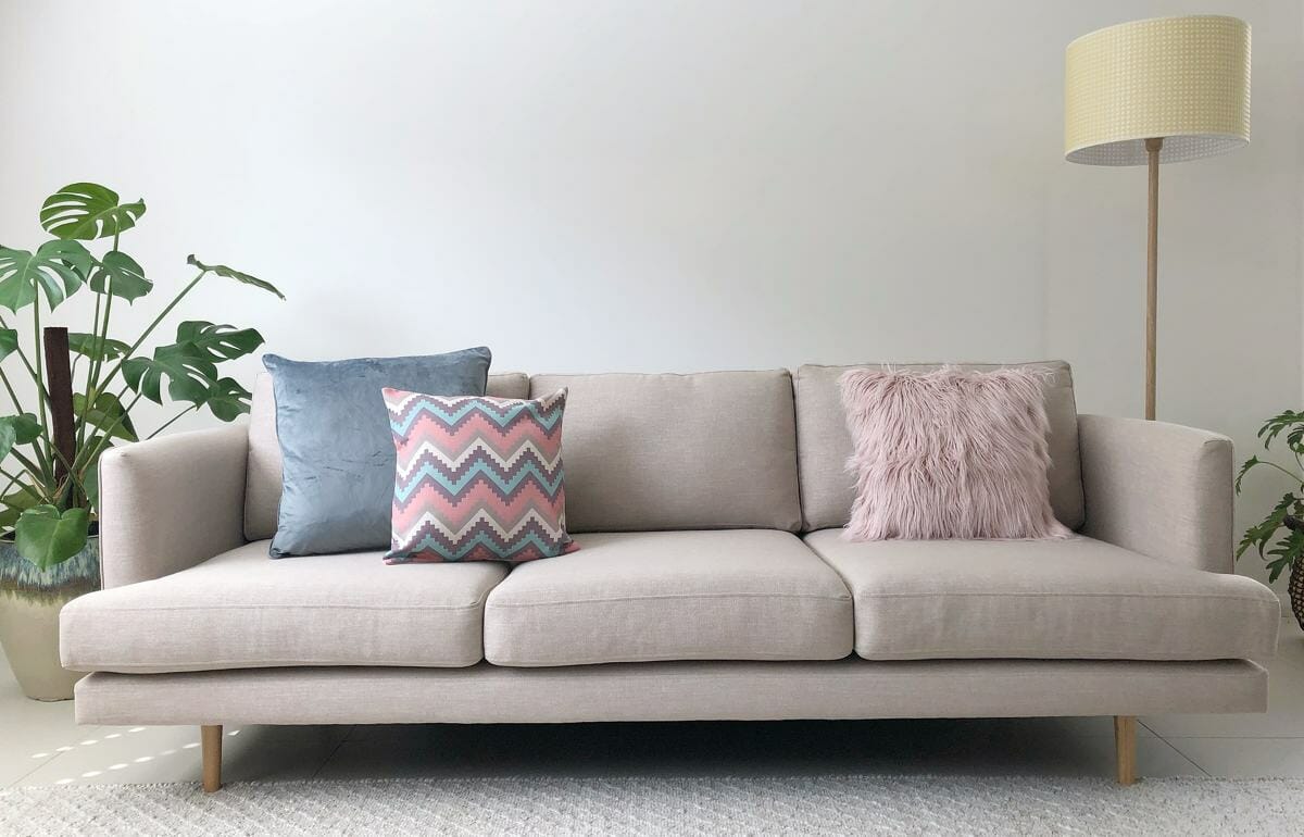 Neutral sofa with cushions in soft blues and pinks