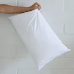A 30x50 cushion insert inner being held up by an arm.