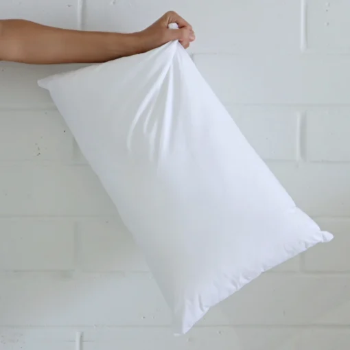 A 30x50 cushion insert inner being held up by an arm.