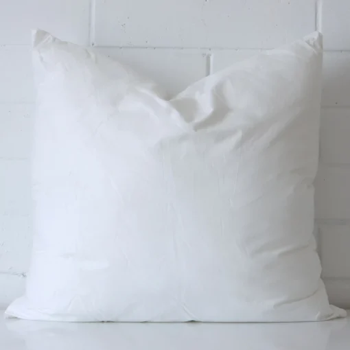 A 55x55 cushion insert inner made with faux feather filling.