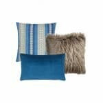 A set of three cushion covers with one square blue vertical stripe cover, one faux fur square cushion cover and a rectangular blue cushion cover.
