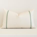 Striking rectangle cream cushion cover featuring a stripe style on quality outdoor fabric.