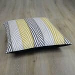 Photo of yellow and grey cushion cover with arrow design