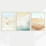 A collection of beach scene wall art prints in coastal colours in a set of 3