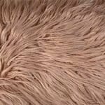 Close up of rectangular blush faux fur cushion in 30cm x 50cm
