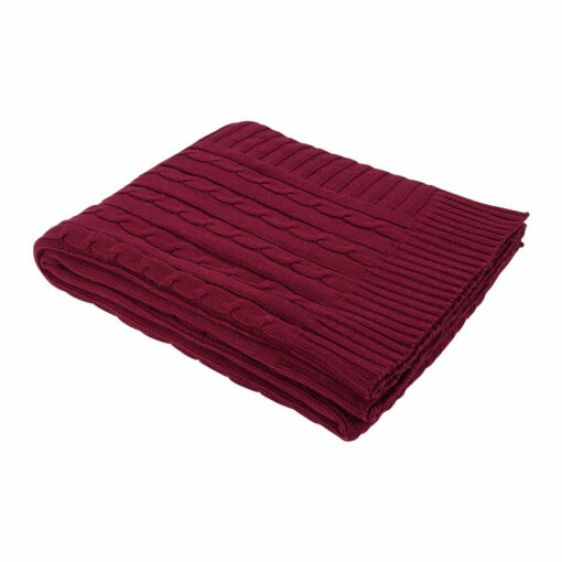 A rich and luxurious burgundy knitted throw