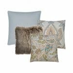 A set of cushions with a pair of paisley cushion covers, one teal square cushion cover and a brown fluffy cushion cover.