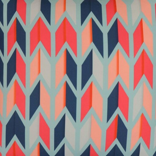 Close up image of colourful, carnival-inspired outdoor cushion cover with arrow design