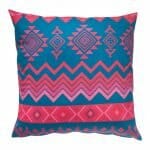 Image of pink and blue outdoor cushion with zigzag and diamond patterns
