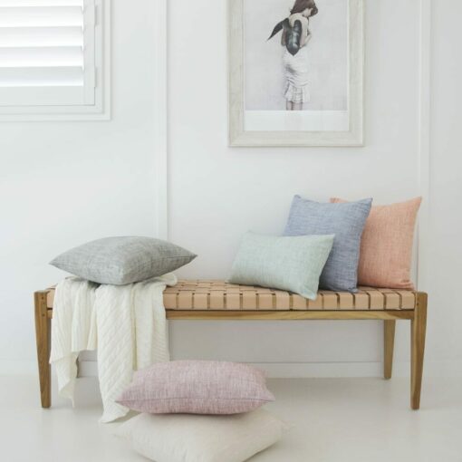 Beautiful collection of panama cushion covers arranged with white knit throw blanket and in white coloured wall