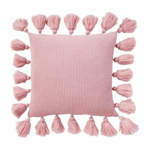 Close up image of pink knitted cushion with tassels