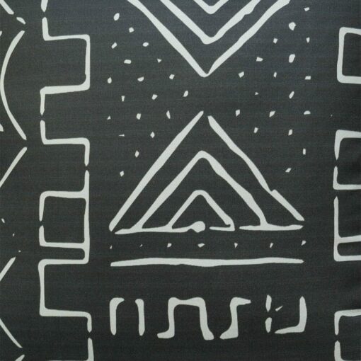 Close up image of black cushion cover with white geometric print