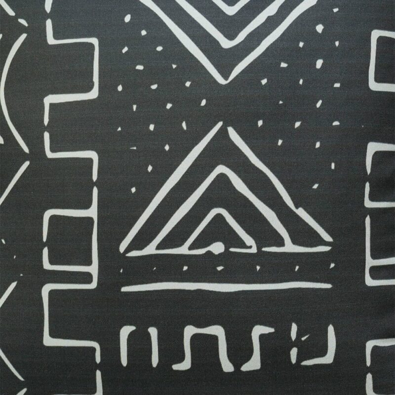 Close up image of black cushion cover with white geometric print