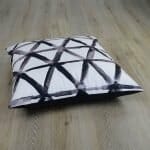 Photo of white floor cushion with black triangles