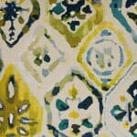 Close up image of yellow, teal and blue cushion cover with Farsi motif