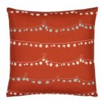 Photo of red Christmas-inspired cushion with a string of bells