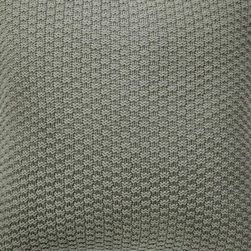 Close up image of grey cushion cover made of knit fabric