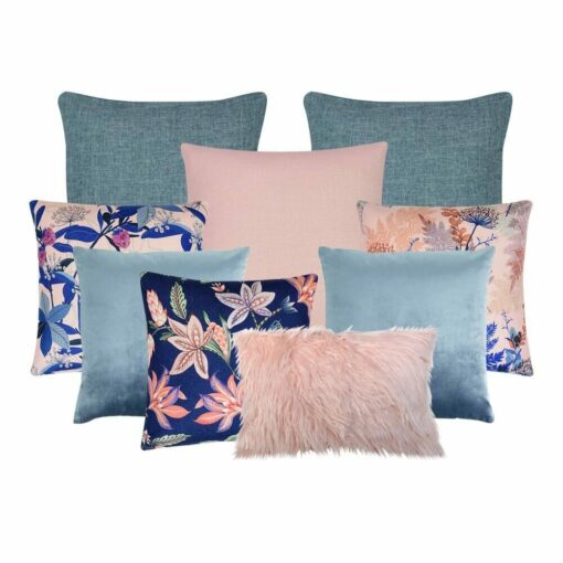 A collection of nine cushions in blue and pink colors and floral designs.