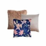 An image of a rose faux fur square cushion, a pink velvet cushion and a blue floral cushion.