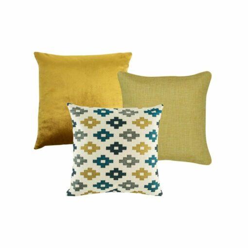 A set of three cushions featuring a gold velvet cushion, a yellow cushion and a blue and yellow cross pattern cushion.