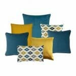 Three blue square cushions, two yellow square cushions and two blue and yellow patterned cushions in a set of seven.
